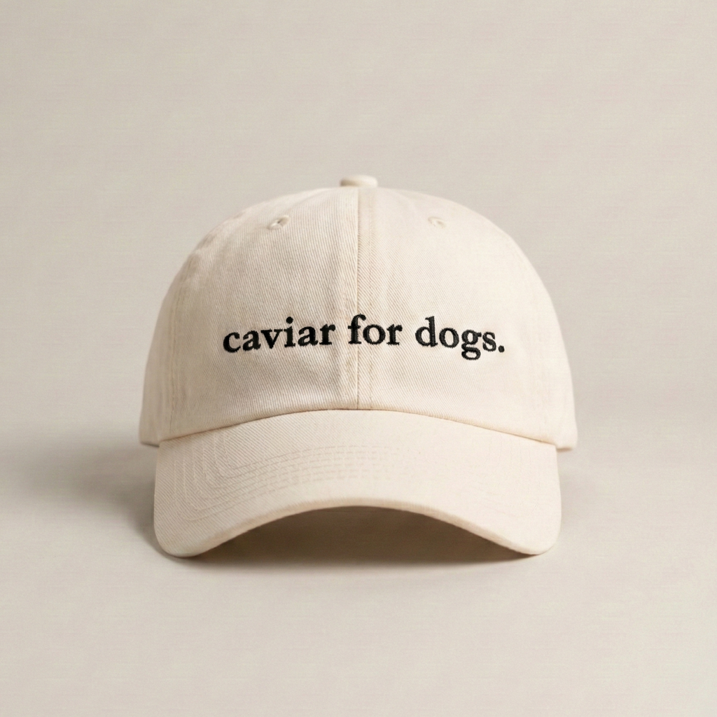 Snarky Barks 'caviar for dogs.' cream embroidered dad hat with adjustable snap back, front view