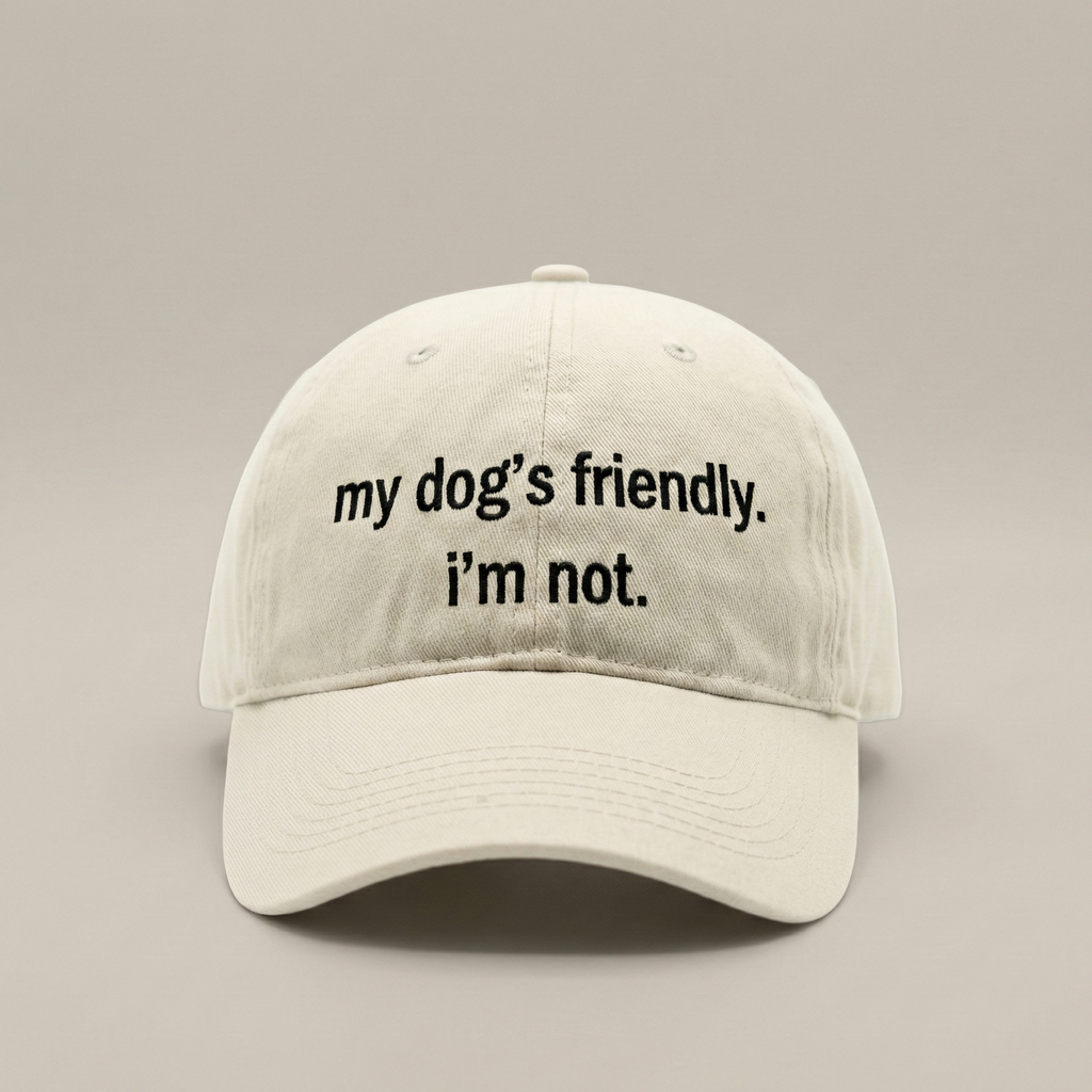 Snarky Barks 'my dog's friendly. i'm not.' cream embroidered dad hat, front view