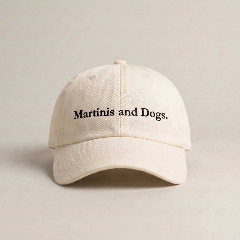 Snarky Barks 'Martinis and Dogs.' cream embroidered dad hat, front view