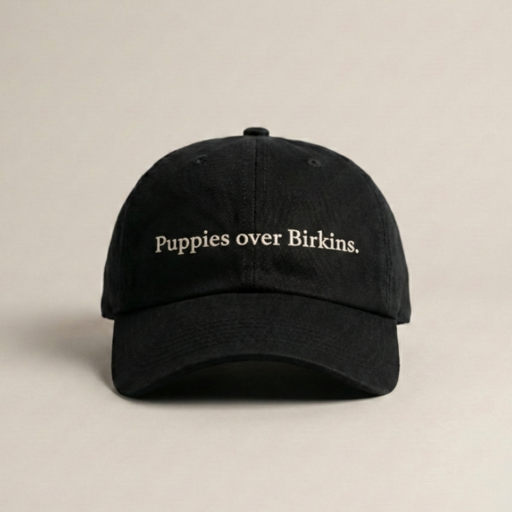Snarky Barks 'Puppies over Birkins.' black embroidered dad hat, front view