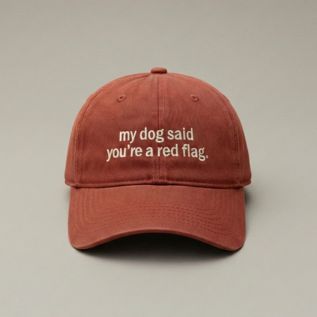 Snarky Barks 'my dog said you're a red flag.' burnt red embroidered dad hat, front view