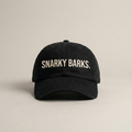 Snarky Barks logo black embroidered dad hat with adjustable snap back, front view