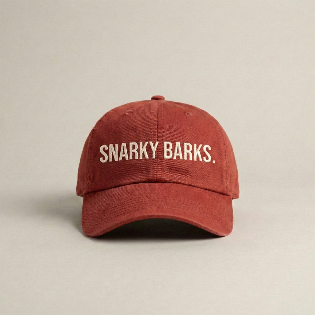 Snarky Barks logo burnt red embroidered dad hat with adjustable snap back, front view